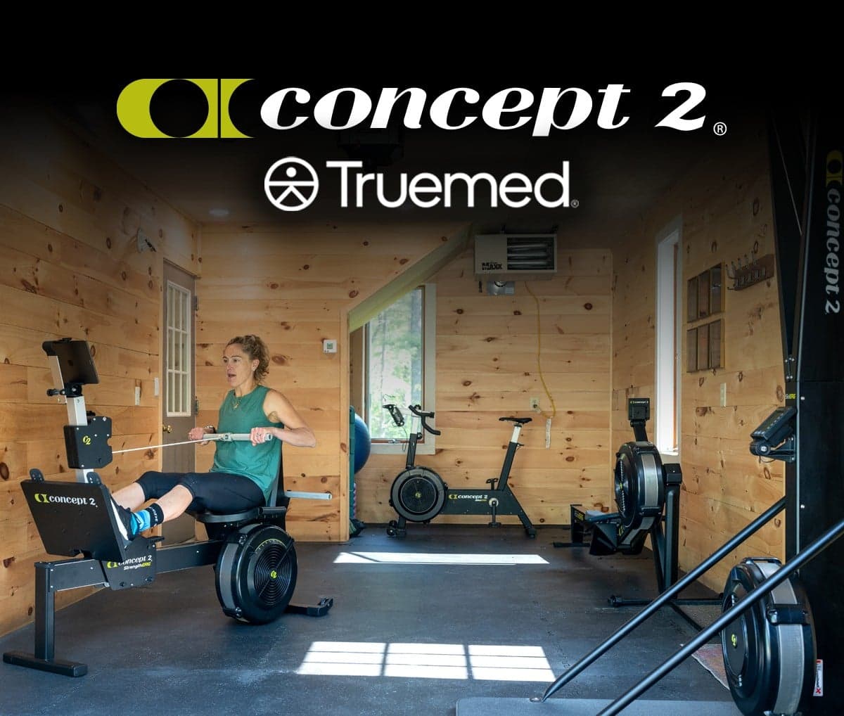 Woman working out in gym with Concept2 Ergs