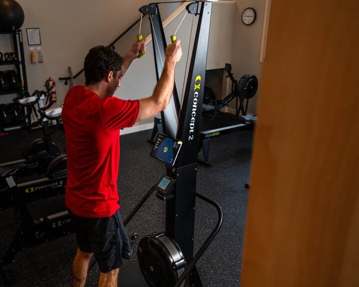 Man using Concept2 SkiErg in gym