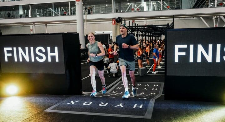 HYROX mised doubles partners cross finish line